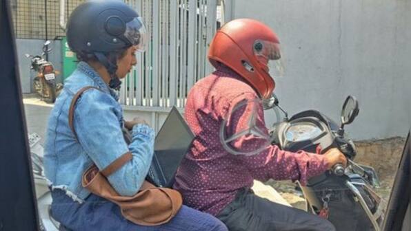 Stuck in Bengaluru traffic, woman balances laptop and starts working on Rapido bike