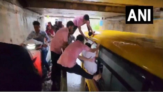 WATCH: Gujarat locals rescue students after bus gets stuck in waterlogged underpass WATCH: Gujarat locals rescue students after bus gets stuck in waterlogged underpass