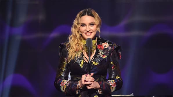 Madonna spends several days in an intensive care unit after becoming ill, postpones upcoming Celebration tour