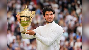 Spain's Carlos Alcaraz celebrates with the trophy after beating Serbia's Novak Djokovic to win the final of the men's singles on day fourteen of the Wimbledon tennis championships in London, Sunday, July 16, 2023. (AP Photo/Kirsty Wigglesworth)