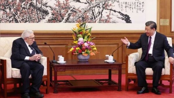 What is Kissinger doing in Xi Jinping's arms?