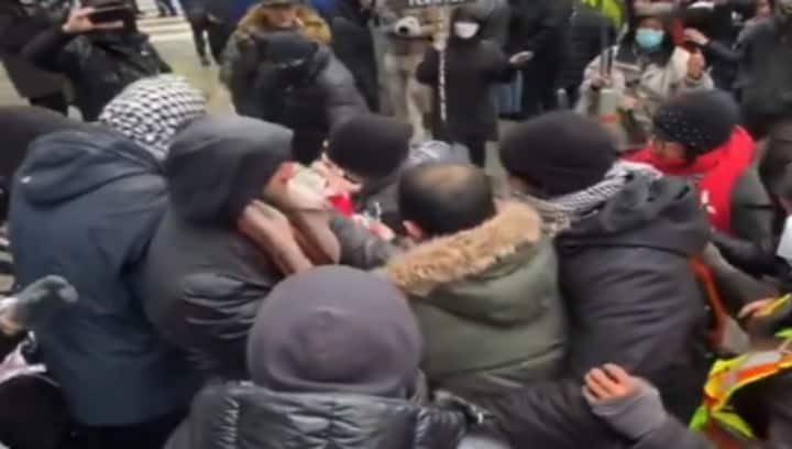 WATCH: Anti-Iran activist waving Canadian flag mauled by pro-Hamas crowd in Toronto as police watch on