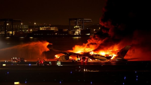 Crews begin clearing plane wreckage from Japan runway collision