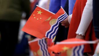 Students holding national flags of China and Kiribati wait for a welcoming ceremony for Kiribati's president at the Great Hall of the People in Beijing, China January 6, 2020. REUTERS/Jason Lee/File Photo