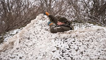 A Ukrainian serviceman of 93rd brigade camouflages a 2S1 Gvozdika self propelled howitzer at a front line, amid Russia's attack on Ukraine, near the town of Chasiv Yar in Donetsk region, Ukraine, 22 February 2024. Reuters File Photo
