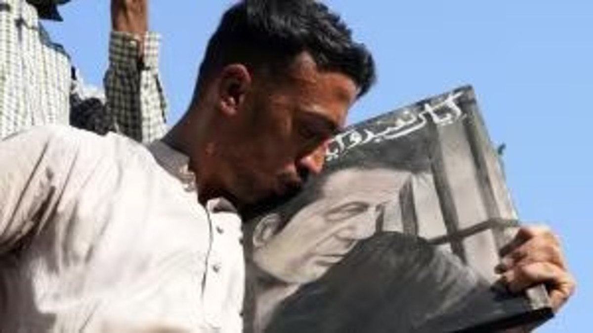 A supporter of Pakistan's former prime minister Imran Khan kisses the portrait of his leader during a protest against the delaying result of parliamentary election by Pakistan election commission, in Karachi. Khan-backed indepedents secured the most seat in the polls. AP A supporter of Pakistan's former prime minister Imran Khan kisses the portrait of his leader during a protest against the delaying result of parliamentary election by Pakistan election commission, in Karachi. Khan-backed indepedents secured the most seat in the polls. AP