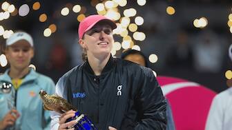 Poland's Iga Swiatek holds the trophy after winning the Qatar Open final against Kazakhstan's Ekaterina Rybakina in Doha, Qatar, on Saturday, Feb. 17, 2024. (AP Photo/Hussein Sayed)