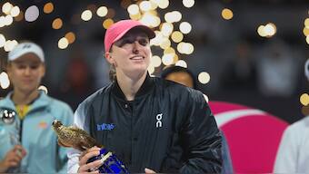 Poland's Iga Swiatek holds the trophy after winning the Qatar Open final against Kazakhstan's Ekaterina Rybakina in Doha, Qatar, on Saturday, Feb. 17, 2024. (AP Photo/Hussein Sayed)