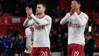 Manchester United's Diogo Dalot, left, and Raphael Varane applaud to supporters after the victory in English FA Cup fifth round vs Nottingham Forest. AP