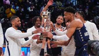 The East team, lead by captain Milwaukee Bucks forward Giannis Antetokounmpo, right, hoists the trophy after defeating the West 211-186 in the NBA All-Star basketball game in Indianapolis, Sunday, Feb. 18, 2024. (AP Photo/Darron Cummings)
