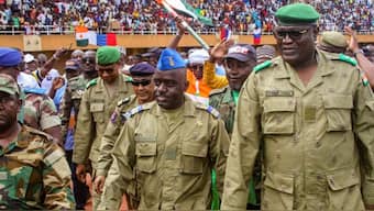 Members of a military council that staged a coup in Niger attend a rally at a stadium in Niamey, Niger. FILE/REUTERS