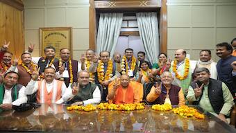 Uttar Pradesh CM Yogi Adityanath and other BJP leaders with party candidates elected to the Rajya Sabha on 27 February. PTI 