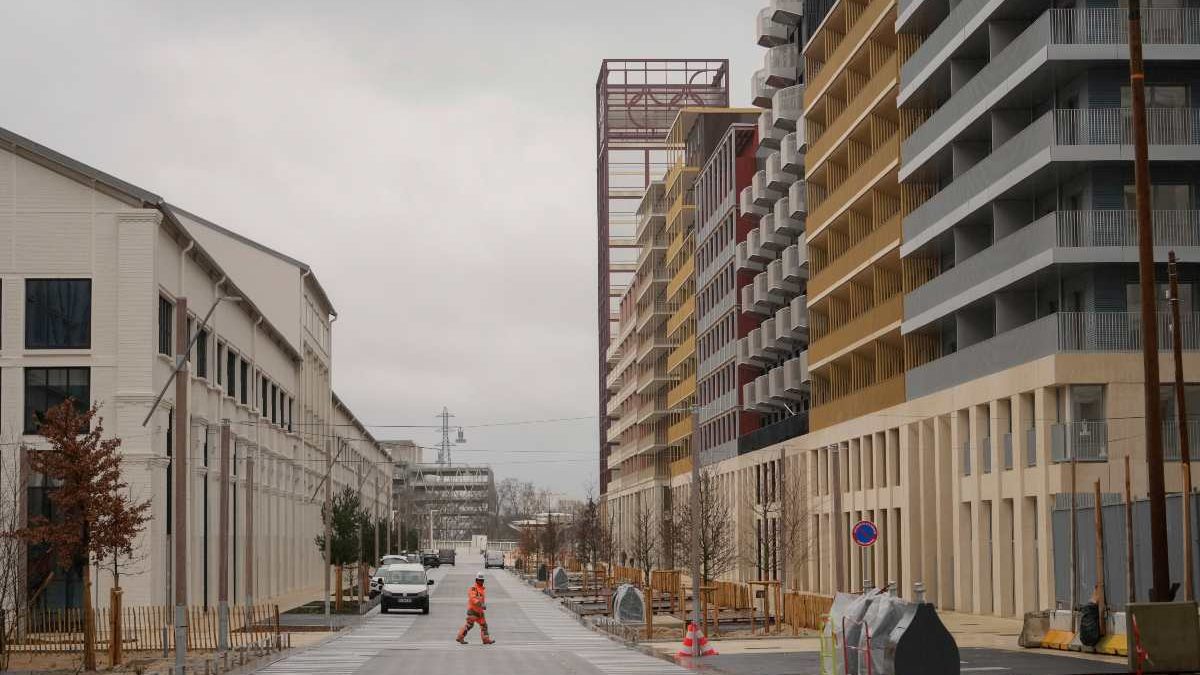 A worker walks in a street of the Olympic village, in Saint-Denis, north of Paris. AP A worker walks in a street of the Olympic village, in Saint-Denis, north of Paris. AP