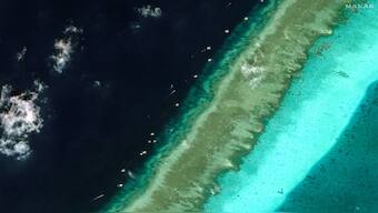 Philippine vessels are seen around Scarborough Shoal in the South China Sea. Maxar Technologies/Handout via Reuters