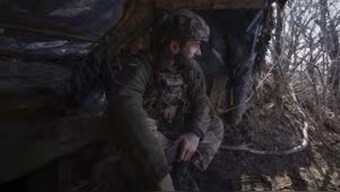 A Ukrainian soldier looks out of a shelter at the frontline in the Donetsk region, Ukraine, on 25 February. AP 