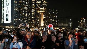 People watch the fireworks show over the Victoria Harbour on the second day of the Lunar New Year of the Dragon, in Hong Kong, China February 11, 2024. REUTERS