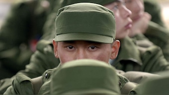 A group of Chinese army new recruits wait for their trains at the railway station in Hefei, central China's Anhui province 10 before departing for basic training. Since last year, Chinese companies are setting up their own private armies. File photo/AFP