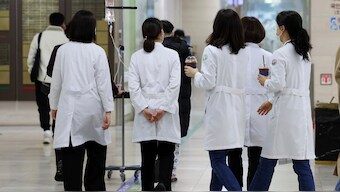Medical workers walk inside a general hospital in Gwangju, South Korea, Monday. AP