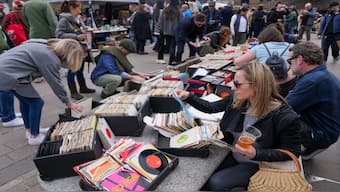 People browse vinyl records at a Classic Car Boot Sale in Kings Cross alongside designer-makers, street food and classic vehicles, in London, 15 April 2023. Reuters File Photo
