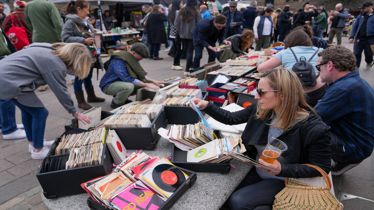 People browse vinyl records at a Classic Car Boot Sale in Kings Cross alongside designer-makers, street food and classic vehicles, in London, 15 April 2023. Reuters File Photo People browse vinyl records at a Classic Car Boot Sale in Kings Cross alongside designer-makers, street food and classic vehicles, in London, 15 April 2023. Reuters File Photo