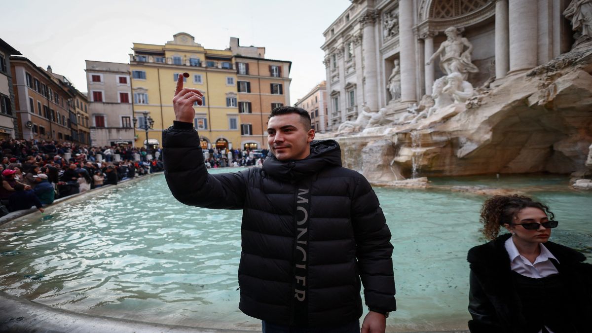 A visitor throws a coin into the Trevi Fountain in Rome, Italy. Reuters A visitor throws a coin into the Trevi Fountain in Rome, Italy. Reuters