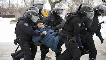 Police detain a man trying to lay flowers to honour Alexei Navalny at a monument in St. Petersburg, Russia, to victims of Soviet repression. File image/AP