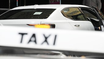 An Uber vehicle stops across the road from a taxi rank in Sydney, 18 March 2024. AP 