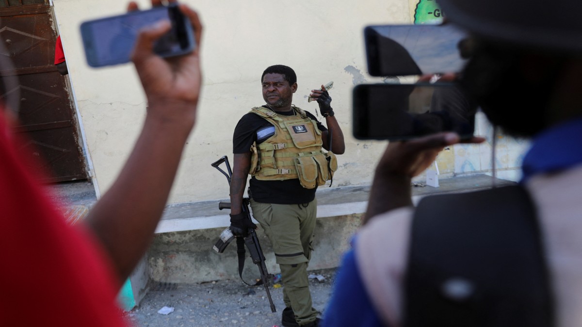 Former police officer Jimmy "Barbecue" Cherizier, leader of the 'G9' gang alliance, holds his phone after a press conference in Delmas 6, Port-au-Prince, Haiti. Reuters Former police officer Jimmy "Barbecue" Cherizier, leader of the 'G9' gang alliance, holds his phone after a press conference in Delmas 6, Port-au-Prince, Haiti. Reuters