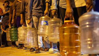 People wait in a queue to collect drinking water amid the ongoing water crisis in Bengaluru on 15 March, 2024. PTI