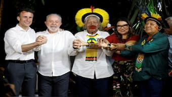 French President Emmanuel Macron, Brazilian President Luiz Inacio Lula Da Silva, Brazilian Indigenous leader of the Kayapo people Raoni Metuktire, Brazilian First Lady Rosangela Janja Da Silva, and Brazilian Yanomami shaman and spokesperson for Yanomami people Davi Kopenawa Yanomami gesture during a meeting at Combu Island, in front of Belem, state of Para, Brazil. AFP