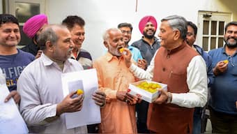 BJP leader Manoranjan Kalia celebrates with migrants from Pakistan after the central government notified the rules for implementation of the Citizenship (Amendment) Act, 2019, in Jalandhar,  on 12 March, 2024. PTI