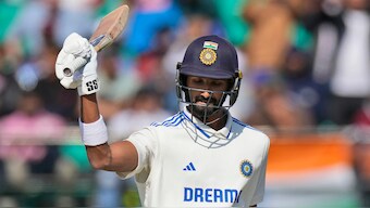 India's Devdutt Padikkal raises his bat in celebration after completing his half-century on debut on Day 2 of the fifth Test against England in Dharamsala. AP