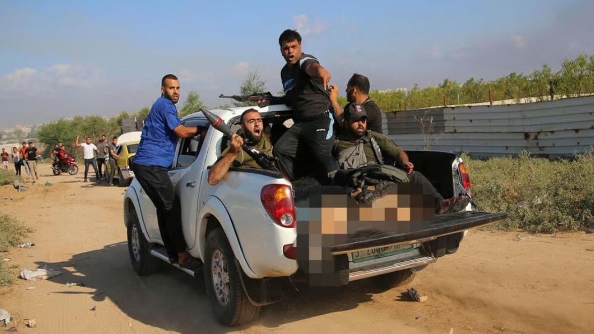 The picture shows the half-naked body of German-Israeli Shani Louk alongside gun-wielding Hamas terrorists. Image Courtesy: @AvivaKlompas/X The picture shows the half-naked body of German-Israeli Shani Louk alongside gun-wielding Hamas terrorists. Image Courtesy: @AvivaKlompas/X