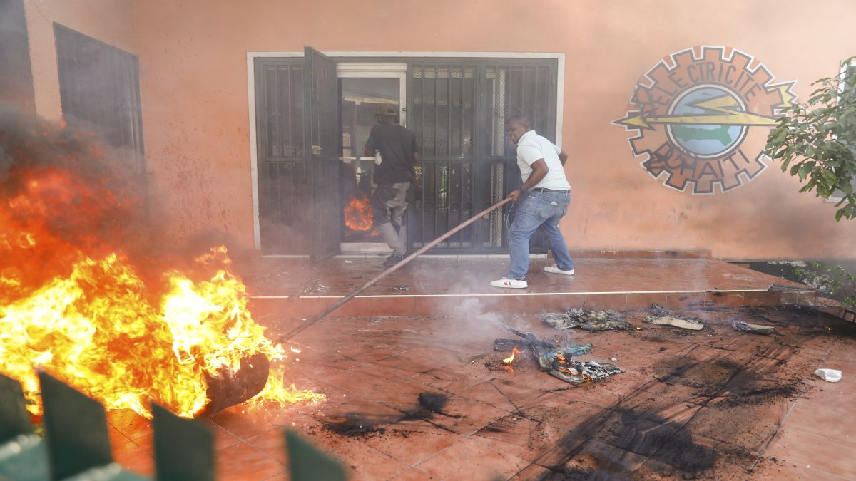 Workers put down a fire set at an office of Haiti's power company during a protest to demand the resignation of the Prime Minister Ariel Henry in Port-au-Prince, Haiti. AP Workers put down a fire set at an office of Haiti's power company during a protest to demand the resignation of the Prime Minister Ariel Henry in Port-au-Prince, Haiti. AP