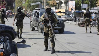 Members of the General Security Unit of the National Palace, USGPN, set up a security perimeter around one of the three downtown stations after police fought off an attack by gangs the day before, in Port-au-Prince, Haiti, on 9 March, 2024. AP