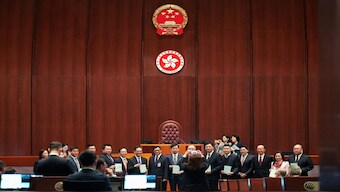 Hong Kong security chief Chris Tang poses for photos with lawmakers as they hold drafts of the Safeguarding National Security Bill, also referred to as Basic Law Article 23, before the second reading at Hong Kong’s Legislative Council, in Hong Kong, China. Reuters