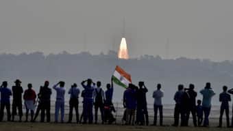 (File) People watch as as a rocket from  Space agency Indian Space Research Organisation takes off  successfully to launch a record 104 satellites, including India’s earth observation satellite on-board PSLV-C37 from the spaceport of Sriharikota. PTI