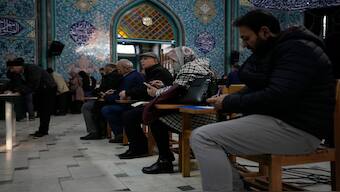 Voters fill out their ballots in the parliamentary and Assembly of Experts elections at a polling station in Tehran, Iran. AP