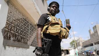 Former police officer Jimmy "Barbecue" Cherizier, and leader of an alliance of armed groups, speaks to a news outlet on a mobile phone during a news conference, in Port-au-Prince, Haiti, on 11 March, 2024. Reuters