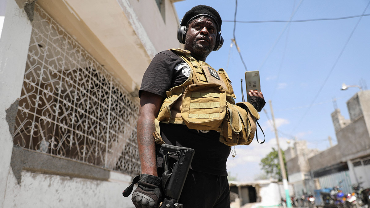 Former police officer Jimmy "Barbecue" Cherizier, and leader of an alliance of armed groups, speaks to a news outlet on a mobile phone during a news conference, in Port-au-Prince, Haiti, on 11 March, 2024. Reuters Former police officer Jimmy "Barbecue" Cherizier, and leader of an alliance of armed groups, speaks to a news outlet on a mobile phone during a news conference, in Port-au-Prince, Haiti, on 11 March, 2024. Reuters