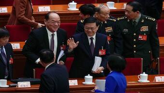 Hong Kong Chief Executive John Lee, center, waves to delegates after the opening session of the National People's Congress (NPC) at the Great Hall of the People in Beijing. AP