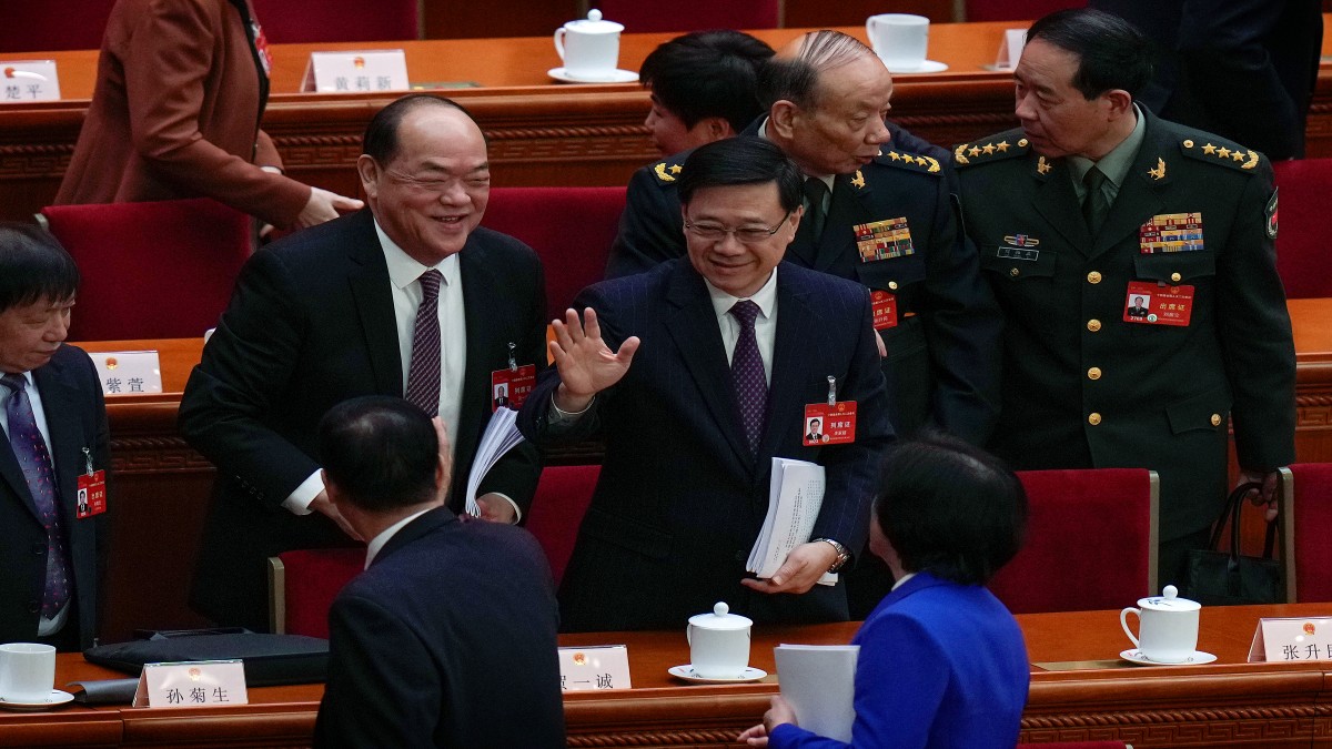 Hong Kong Chief Executive John Lee, center, waves to delegates after the opening session of the National People's Congress (NPC) at the Great Hall of the People in Beijing. AP Hong Kong Chief Executive John Lee, center, waves to delegates after the opening session of the National People's Congress (NPC) at the Great Hall of the People in Beijing. AP