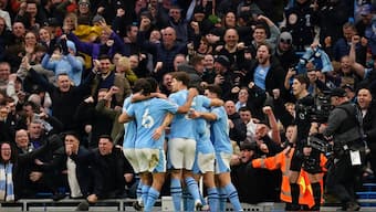 Manchester City players celebrate after scoring against Manchester United in the Premier League. AP