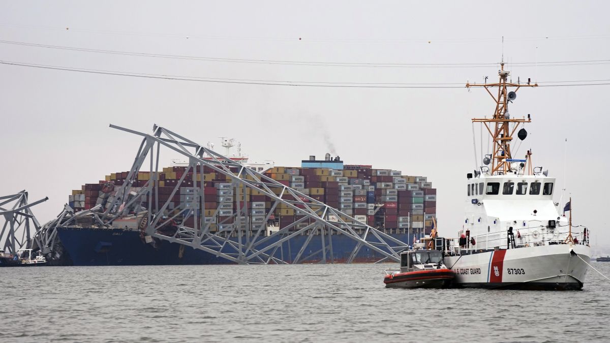 A Coast Guard cutter patrols in front of a cargo ship that is stuck under the part of the structure of the Francis Scott Key Bridge after the ship hit the bridge in Baltimore, US. AP A Coast Guard cutter patrols in front of a cargo ship that is stuck under the part of the structure of the Francis Scott Key Bridge after the ship hit the bridge in Baltimore, US. AP