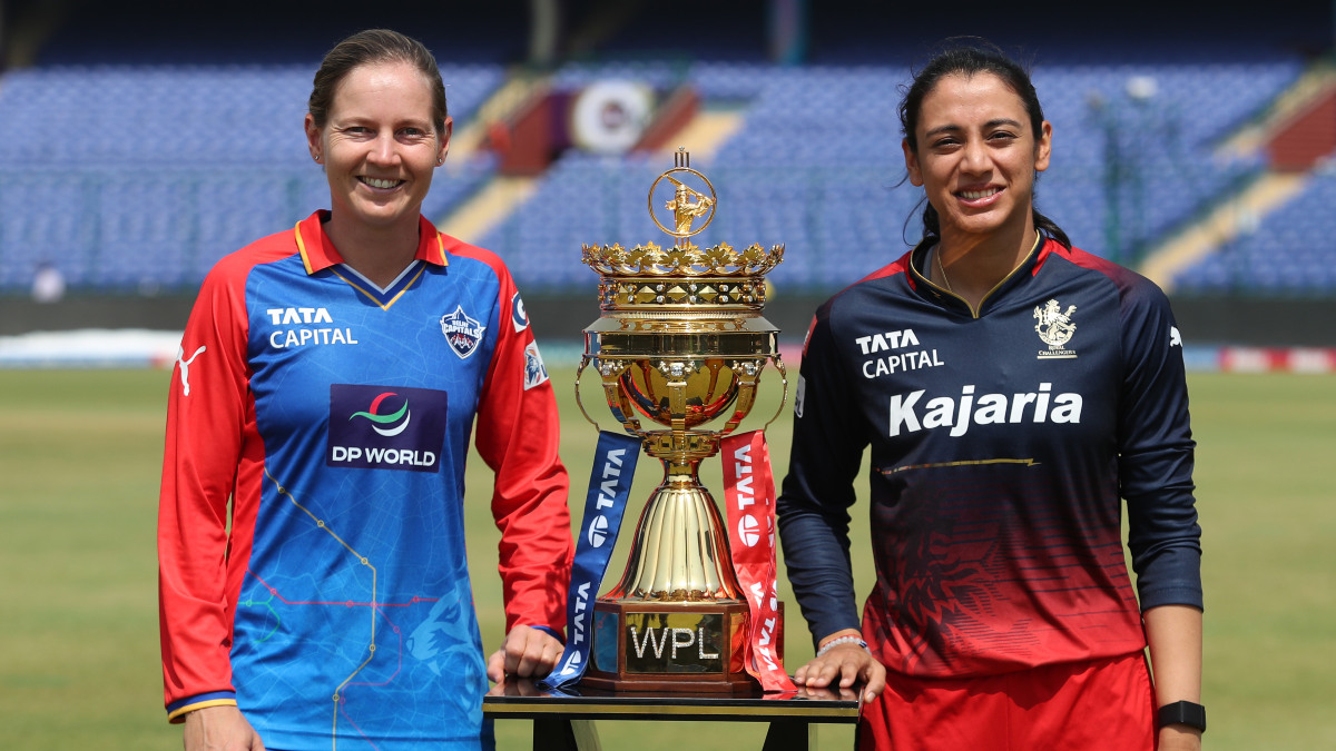 Delhi Capitals captain Meg Lanning and her Royal Challengers Bangalore counterpart Smriti Mandhana pose with the Women's Premier League trophy in Delhi's Arun Jaitley Stadium on the eve of the final of the second season. Sportzpics Delhi Capitals captain Meg Lanning and her Royal Challengers Bangalore counterpart Smriti Mandhana pose with the Women's Premier League trophy in Delhi's Arun Jaitley Stadium on the eve of the final of the second season. Sportzpics