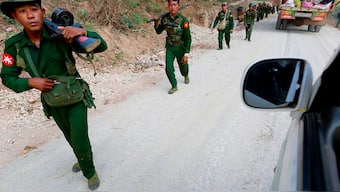 (File) Myanmar army soldiers walk along a road near Laukkai. Reuters