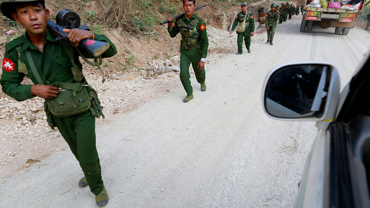 (File) Myanmar army soldiers walk along a road near Laukkai. Reuters (File) Myanmar army soldiers walk along a road near Laukkai. Reuters