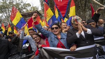 Supporters of Rastriya Prajatantra Party, or national democratic party, wave their flags during a pro-monarchy protest in Kathmandu, Nepal. AP