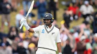 New Zealand all-rounder Rachin Ravindra raises his bat after bringing up his half-century on Day 3 of the first Test against Australia in Wellington. AP