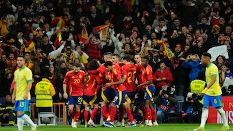Spain players celebrate after Rodrigo scores from the penalty spot against Brazil in Madrid. AP